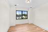 Empty room featuring light wood-style floors, ornamental molding, and recessed lighting