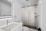 Bathroom with a shower stall and vanity