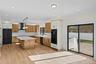 Kitchen featuring black appliances, light wood-style floors, pendant lighting, a kitchen island, and tasteful backsplash