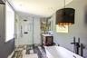 Bathroom with a freestanding bath, a shower stall, vanity, wood finished floors, and recessed lighting