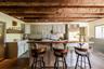 Kitchen with a sink, decorative backsplash, a kitchen breakfast bar, and stainless steel built in refrigerator