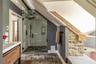 Bathroom with a shower stall, vanity, and lofted ceiling