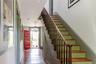 Stairway featuring hardwood / wood-style flooring, a chandelier, and baseboards