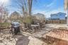 Fenced backyard with a patio, a grill, and outdoor dining space