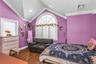 Bedroom featuring ornamental molding, dark wood finished floors, and lofted ceiling