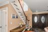 Entrance foyer with stairway, a chandelier, crown molding, and french doors