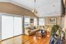 Living area with lofted ceiling, ornamental molding, a chandelier, and light wood-style floors