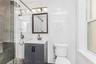Bathroom featuring tile walls, vanity, and a stall shower