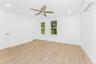 Empty room with a wall mounted AC, light wood-style floors, a ceiling fan, and recessed lighting