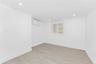 Empty room with a wall mounted AC, light wood-style floors, recessed lighting, and a smoke detector