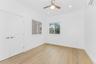 Unfurnished bedroom featuring light wood-type flooring, an AC wall unit, recessed lighting, and a ceiling fan