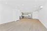 Unfurnished living room with an AC wall unit, light wood-type flooring, and recessed lighting