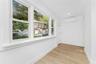 Empty room featuring a wall mounted AC, light wood-style flooring, and recessed lighting