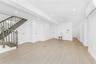 Unfurnished living room featuring a wall mounted air conditioner, light wood-style flooring, recessed lighting, and stairway