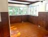 Spare room featuring light wood-style flooring and beam ceiling