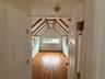 Bonus room featuring light wood-type flooring and baseboards