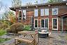 Expansive stone patio backyard overlooking view.