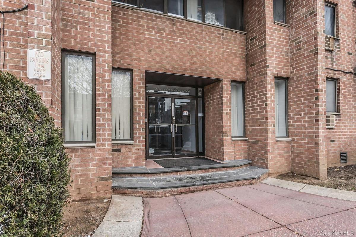 Entrance to property with brick siding
