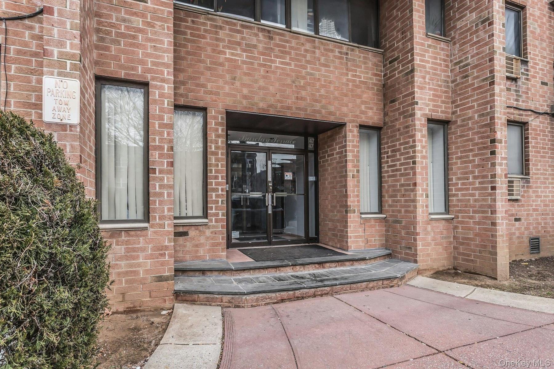 Entrance to property with brick siding