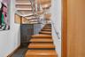 leading to downstairs bedrooms each with private full bath.