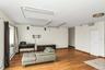 Sitting room featuring hardwood / wood-style flooring, baseboard heating, and a baseboard radiator