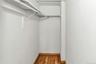 Spacious closet with hardwood / wood-style flooring