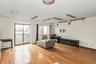 Living room featuring light wood-type flooring and baseboard heating