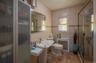 Bathroom featuring radiator heating unit, tile walls, and a stall shower