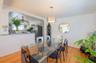Dining room featuring arched walkways, light wood-style flooring, and ceiling fan