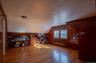Office space with radiator, wooden walls, lofted ceiling, and wood finished floors