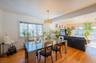 Dining room with light wood-type flooring and healthy amount of natural light