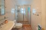 Full bath with tile walls and a shower stall