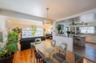 Dining space with light wood-style flooring and ceiling fan