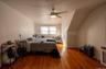 Bedroom featuring wood finished floors, vaulted ceiling, and ceiling fan