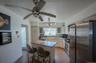 Kitchen featuring stainless steel appliances, tasteful backsplash, a kitchen island, a kitchen breakfast bar, and wood finished floors