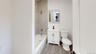Full bath featuring vanity, wood tiled floors, and bathing tub / shower combination