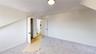 Additional living space with carpet flooring and baseboards