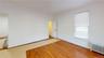 Empty room with radiator and light wood-style floors