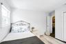 Bedroom with wood-style flooring and baseboards