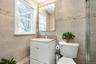 Master Bathroom with vanity, tile walls, and a shower with shower door