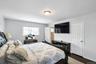Master Bedroom with dark wood-type flooring and baseboards