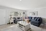 Living area with light wood-style flooring, recessed lighting, and crown molding