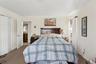 Bedroom featuring carpet floors, ornamental molding, and a closet