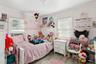 Bedroom featuring light wood finished floors and ornamental molding