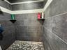 Bathroom with tiled shower in the commercial unit.