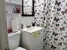 Bathroom featuring vanity and tile walls