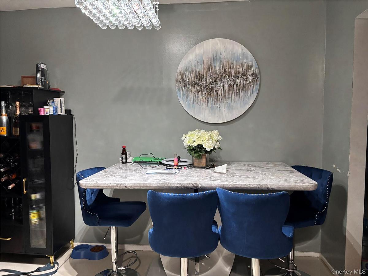 Dining area with a chandelier and baseboards