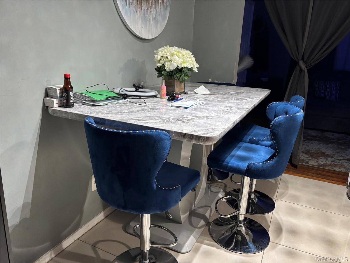 Dining area featuring tile patterned floors and baseboards