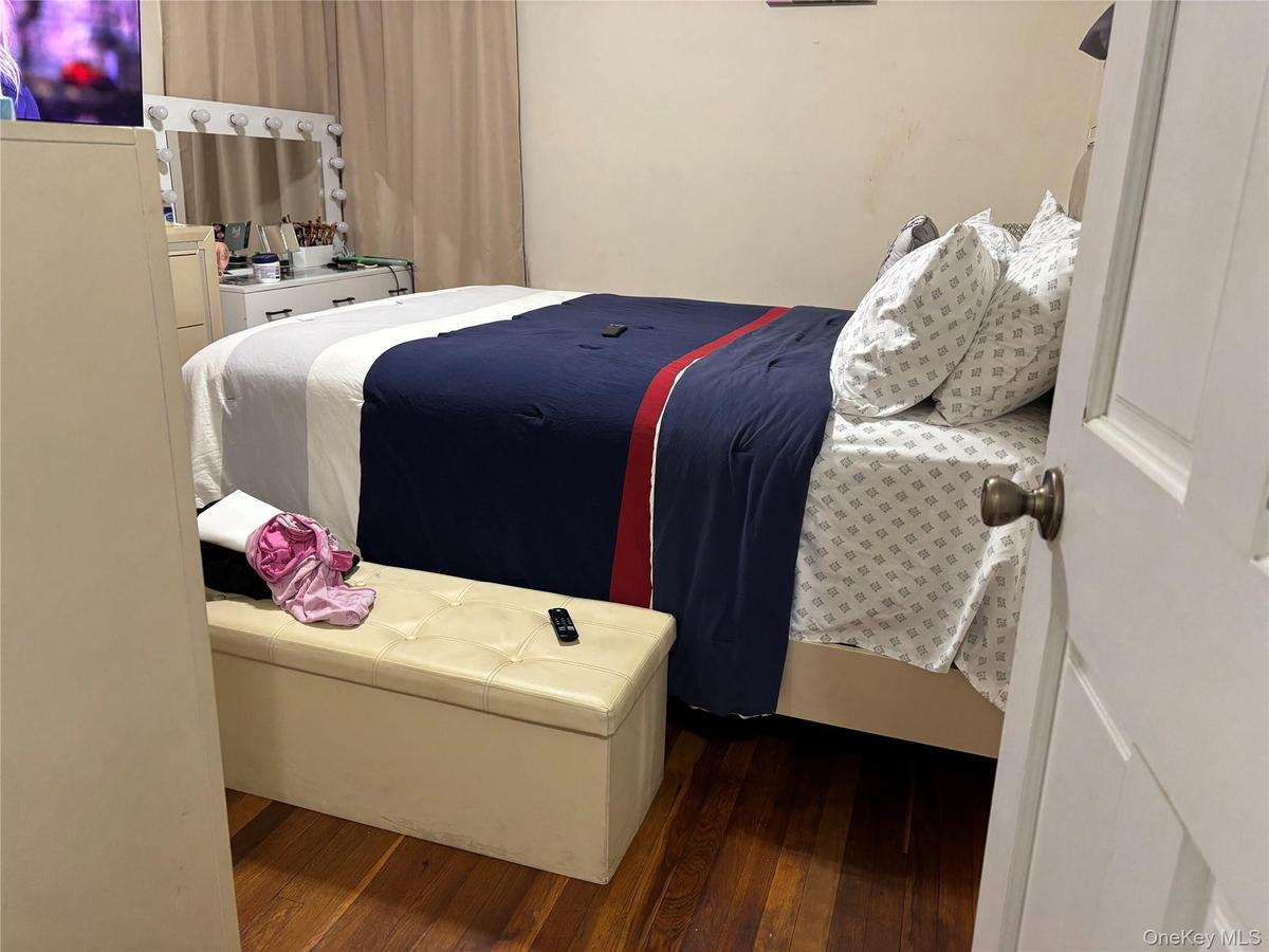 Bedroom with dark wood-style flooring