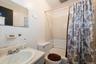 Bathroom featuring a sink and shower / bath combination with curtain